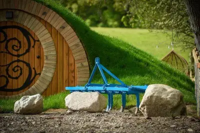 a blue bench in front of a wooden building at Panteg in Llanrhaeadr-ym-Mochnant