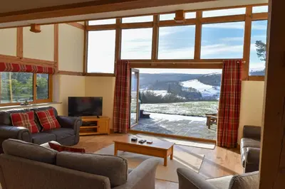 a living room with a couch and a tv at The Hayloft in Knighton