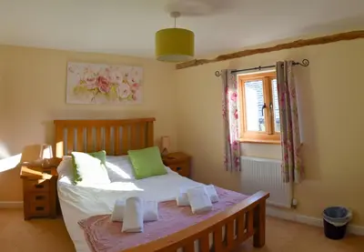 a bedroom with a bed and a window at The Hayloft in Knighton