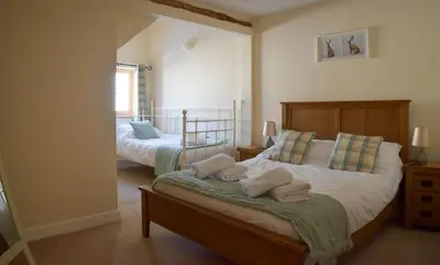a bedroom with two beds with towels on them at The Hayloft in Knighton