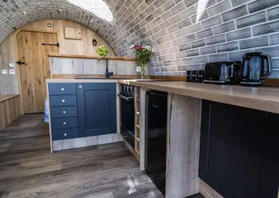 a kitchen with a counter and a brick wall at Valley View in Llanfair Caereinion