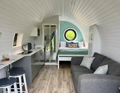 a living room with a couch and a bed in a room at Y Dderwen in Oswestry