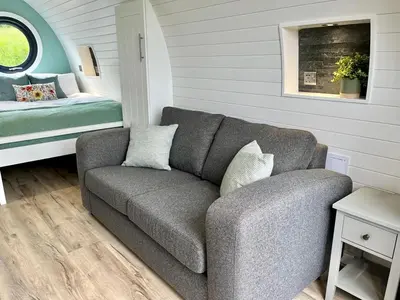 a living room with a couch and a bed at Y Dderwen in Oswestry