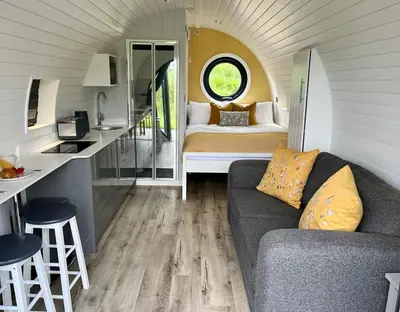 a living room with a couch and a bed in a room at Yr Onnen in Oswestry
