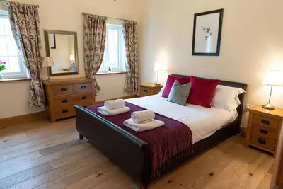 a bedroom with a bed with two towels on it at Yr Hen Beudy in Aberystwyth