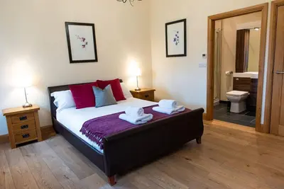 a bedroom with a bed with two towels on it at Yr Hen Beudy in Aberystwyth