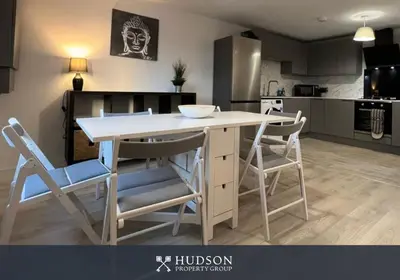 a kitchen with a table and chairs in a room at Open Plan Townhouse in Shrewsbury in Shrewsbury