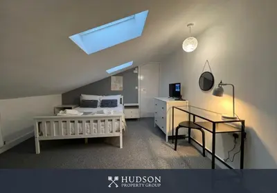 a bedroom with a bed and a desk and a skylight at Open Plan Townhouse in Shrewsbury in Shrewsbury