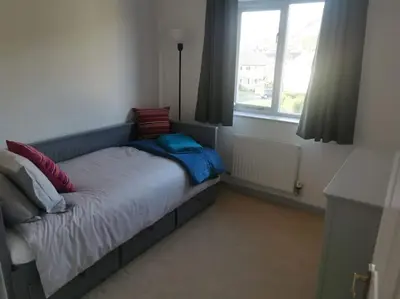 a small bed in a room with a window at Twyngaer, a spacious 3 bedroom bungalow sleeps 5 in Knighton