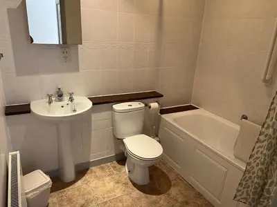 a bathroom with a toilet and a sink and a tub at Twyngaer, a spacious 3 bedroom bungalow sleeps 5 in Knighton