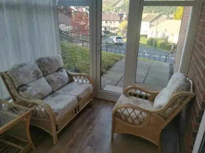 a couch and two chairs in a room with a window at Twyngaer, a spacious 3 bedroom bungalow sleeps 5 in Knighton