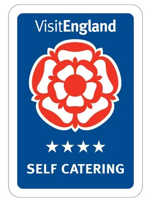 a blue sign with a red flower with the vietlez island self catering at St Milburga Chapel in Stoke Saint Milborough