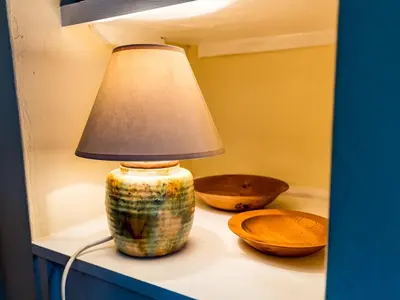 a lamp sitting on a table next to two bowls at Cosy 2 bedroom Victorian Cottage - Pass the Keys in Ludlow