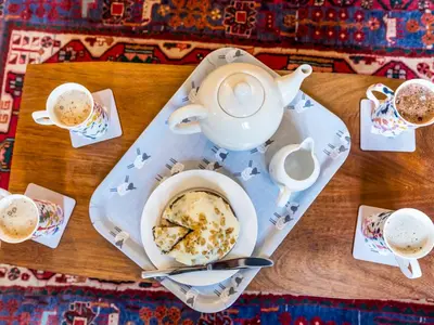 a table with a teapot and a cup of coffee at Cosy 2 bedroom Victorian Cottage - Pass the Keys in Ludlow