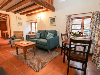 a living room with a couch and a table at Walkmill Barn in Bishops Castle
