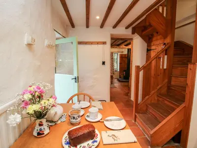 a table with a cake and flowers on it at Walkmill Barn in Bishops Castle