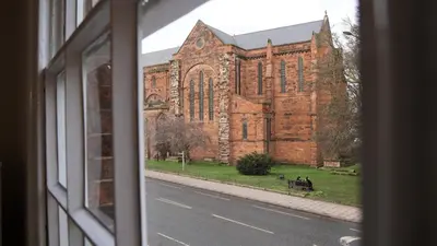 a view of a church from a window at Abbey Foregate in Shrewsbury