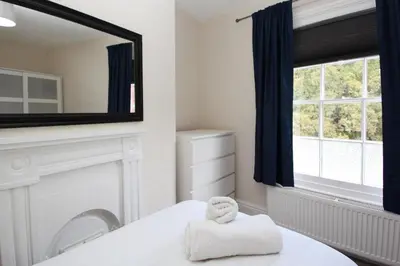 a bathroom with a mirror and a towel on a bed at Abbey Foregate in Shrewsbury