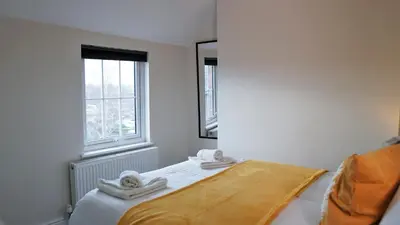 a small bedroom with a bed with towels on it at Abbey Foregate in Shrewsbury