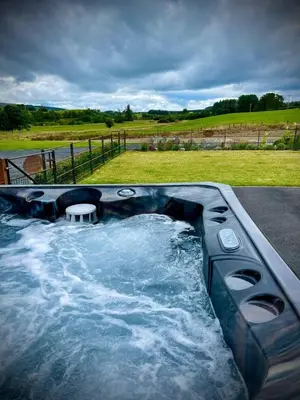 a jacuzzi tub with a table in the middle at Buttercup in Rhayader