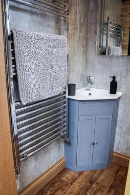 a bathroom with a blue cabinet and a sink at Lily in Rhayader