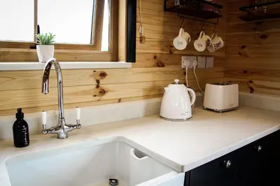 a kitchen counter with a sink in a kitchen at Lily in Rhayader
