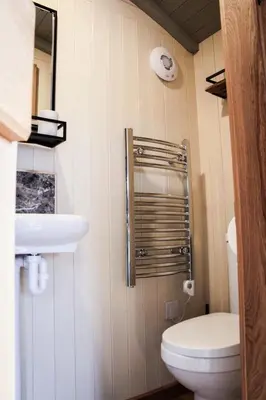 a small bathroom with a toilet and a sink at Rose in Rhayader