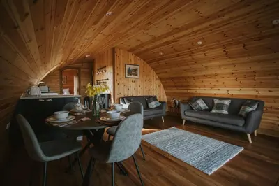 a room with a table and chairs in a cabin at Snowdrop in Rhayader