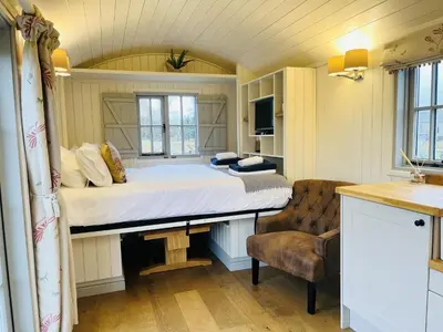 a bedroom with a bed and a chair in a room at Sunflower in Saint Harmon