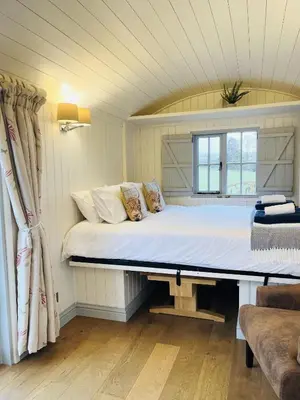 a large bed in a room with a window at Sunflower in Saint Harmon