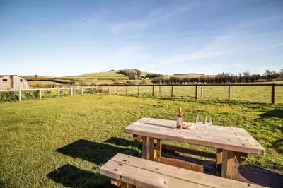 a picnic table in the middle of a field at Sunflower in Saint Harmon