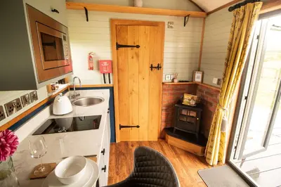 a small kitchen with a sink and a stove at Tulip in Rhayader