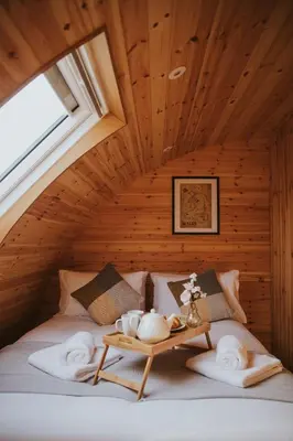 a bedroom with a bed with a table on it at Daisy in Rhayader