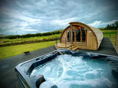 a large hot tub with a gazebo on a house at Daisy in Rhayader
