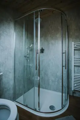 a shower with a glass door in a bathroom at Daisy in Rhayader