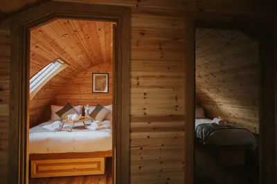 a bedroom in a log cabin with a bed at Daisy in Rhayader
