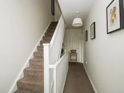 a staircase in a home with a white stair case at 30 Poplar Close in Shrewsbury