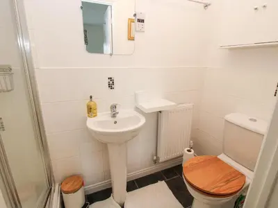 a bathroom with a sink and a toilet and a mirror at 30 Poplar Close in Shrewsbury