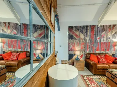 a living room with two couches and a window at Tegfan in Henfynyw Upper