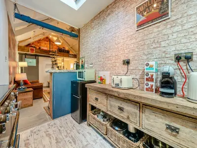 a kitchen with a counter and a brick wall at Tegfan in Henfynyw Upper