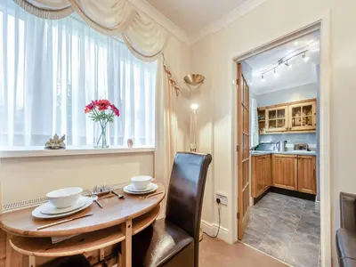 a dining room with a table and a window at Craigfryn in Llanerch-Aeron