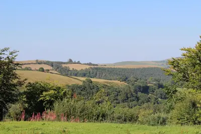 a view of the hills from a field at The Edwardian Caravan 'Dora' in Lampeter