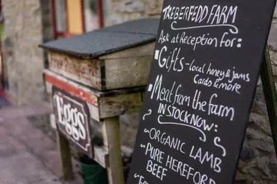 a sign that is next to a table at The Edwardian Caravan 'Dora' in Lampeter