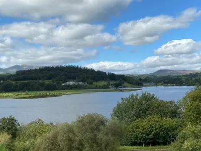a view of a lake with mountains in the background at Llys Mair in Bala
