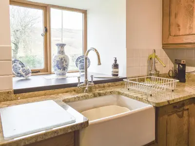 a kitchen with a large sink and a window at Hafan Prysor in Trawsfynydd