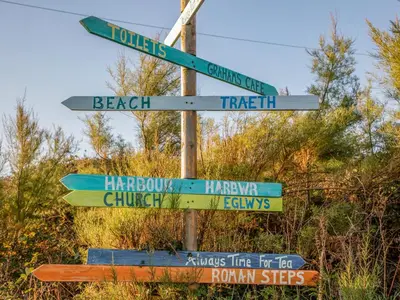 a street sign with many different signs on it at Bramble Bank in Harlech