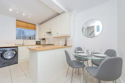a kitchen and dining room with a table and chairs at Hereford Road Shrewsbury Cottage in Shrewsbury