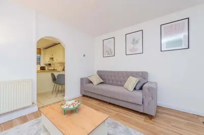 a living room with a couch and a table at Hereford Road Shrewsbury Cottage in Shrewsbury