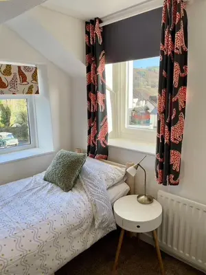 a bedroom with a bed and a window at Taylor Way - Superb Apartment with Living Room and Private Gated Parking in Aberystwyth