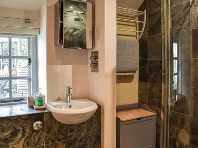 a bathroom with a sink and a shower at Summerhill Tanyrhos in Blaenau-Ffestiniog